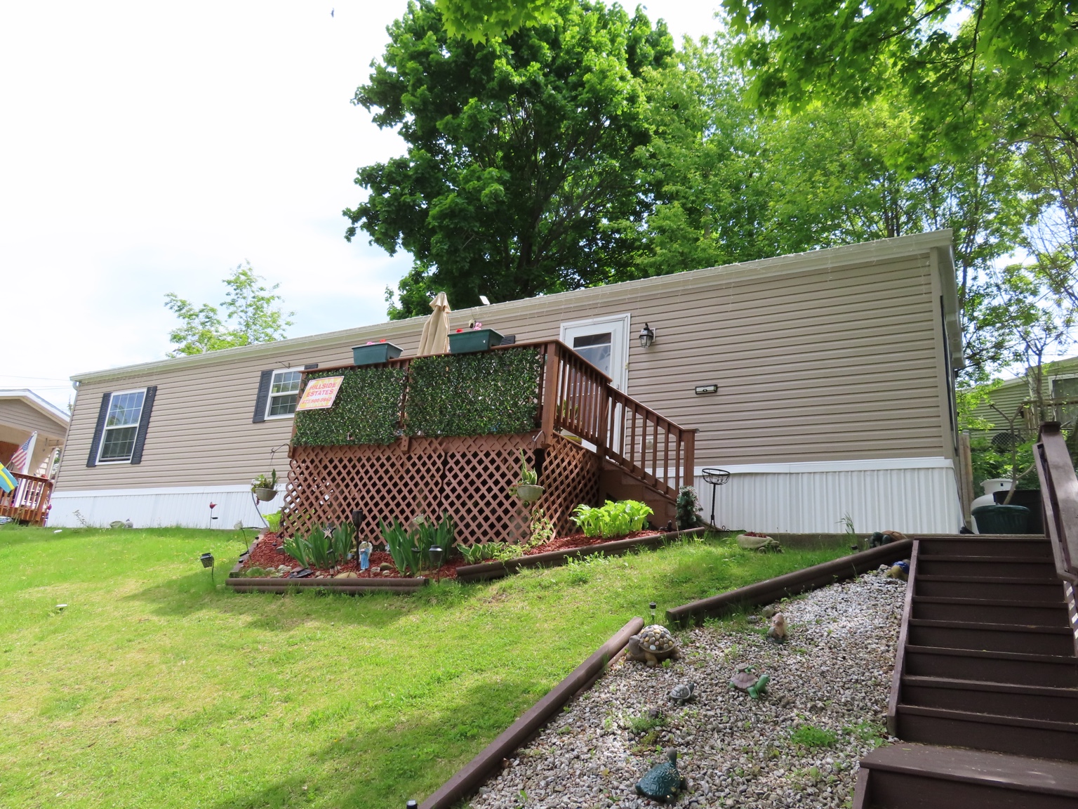 Home with deck and landscaping in Hillside Estates